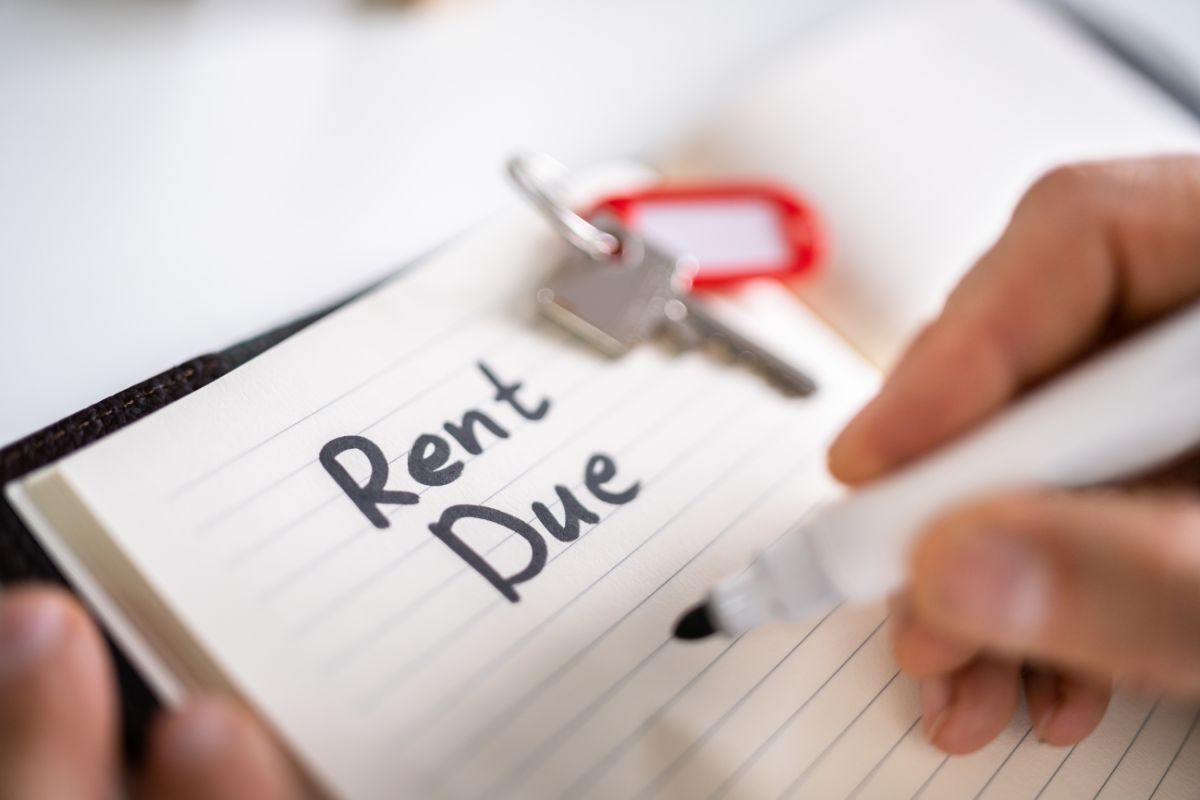 Image for residential tenancy agreement blog post - image of a notepad with a key sitting on it and writing saying "rent due".